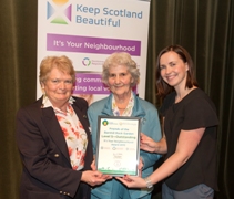 Ann Taylor and Isobel Turner accept the certificate from Katheryn Bennett
